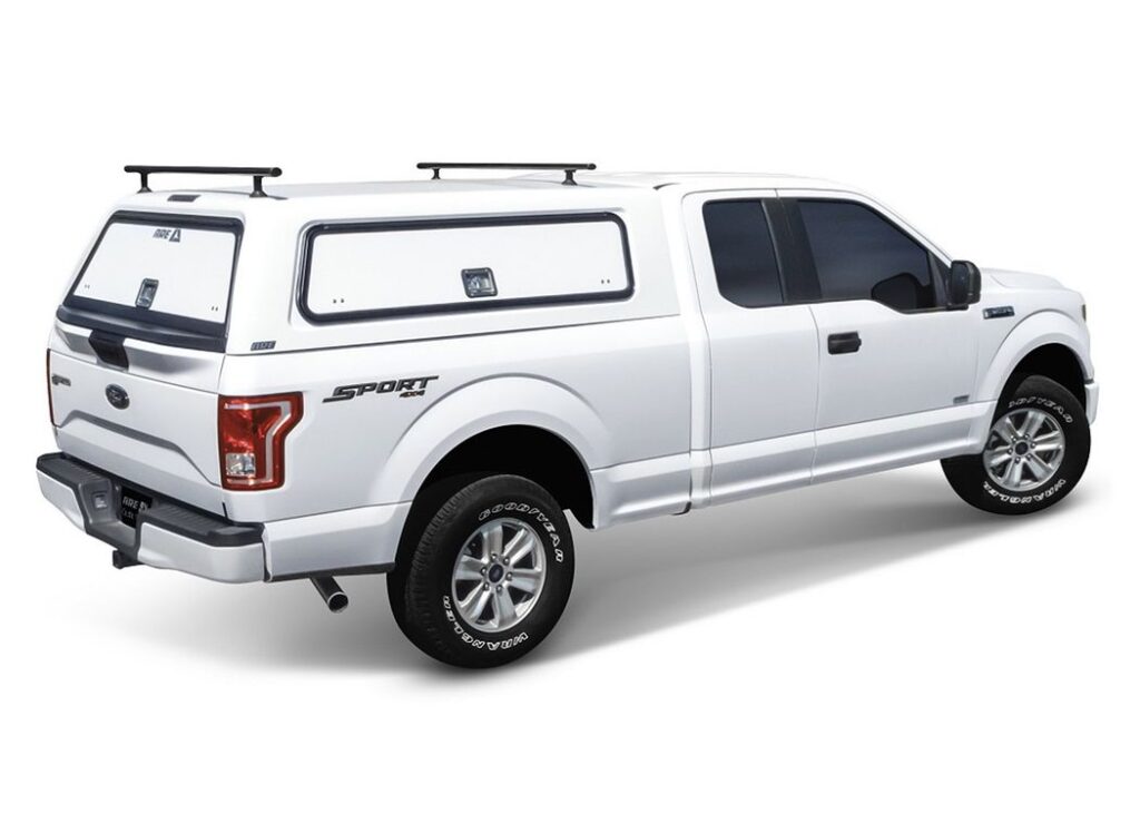 White A.R.E. HD Series heavy-duty truck cap with a roof rack on a white Ford F-150