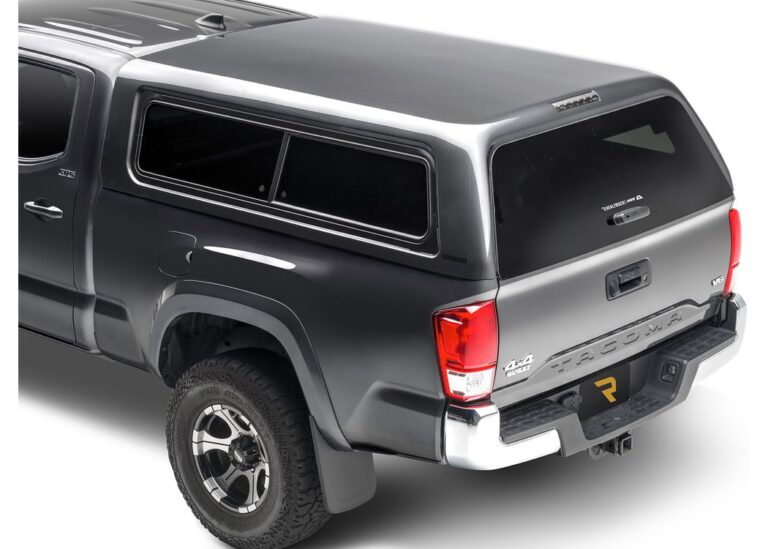 Rear view of a gray, paint-matched A.R.E. CX Evolve truck cap with framed sliding side windows on a gray Toyota Tacoma