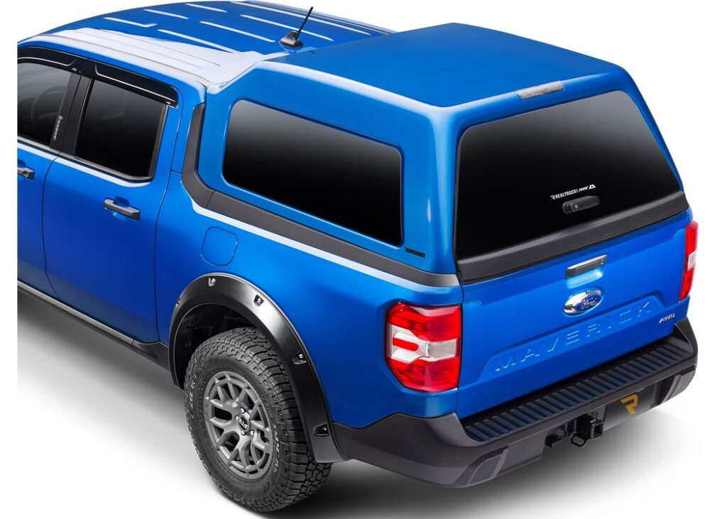 Rear view of a blue, paint-matched A.R.E. MX Series mid-rise truck cap on a blue Ford Maverick